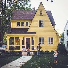 Yellow house with black metal roof. Buyer Beware Pick The Right Roof Shingle Colors Chrissy Marie Blog