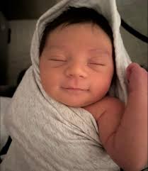 I know they say babies don't smile for about 2 months… but I was up from  2am-7am with her and took this pic around 6am. I'm counting it as a smile.