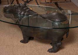 Hippo coffee table, fantasy table made from wood *and **glass *, there is a small **flower pot in the scene.dimension **of the table is: Hippo Table By Mark Stoddart For Sale At 1stdibs