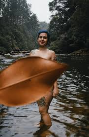 Naked woman in river near forest covering body with leaf · Free Stock Photo