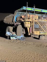 mine worker crushes his own ute with massive haul truck as