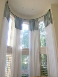 Shades and remote blinds for high windows have top down/bottom up options to preserve the views while providing uv/light filtering. How To Dress Tall Windows