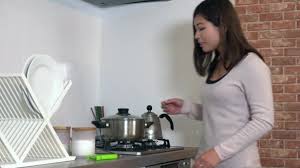 Japanese housewife playing with vegetables in the kitchen. Young Asian Woman Cooking Food Home Pretty Japanese Girl Preparing Stock Video C Dualstock 188478668