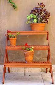 3 tiered stands can be used seasonally (especially christmas) to create beautiful decorations like this one by creative mammas. 3 Tiered Wood Plant Stand Garden Decor Idea Affiliate Home Gardening Outdoor Plants Patio Backyard Plant Stands Outdoor Wood Plant Stand Planter Stand