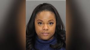 With pride and reverence, crowds watch former President Carter's  flag-draped casket leave hospital