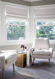 Chic Bay Window Bedroom Sitting Area Boasts A Pair Of Modern White Chairs Flanking A Brass Accent Table Jon Bedroom With Sitting Area Home Modern White Chairs