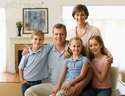 Family Sitting In Living Room Smiling Portrait Family Portrait Poses Family Portraits Portrait