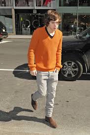 Casual harry styles.looking at his shoes | harry styles. Harry Styles Style Evolution British Vogue
