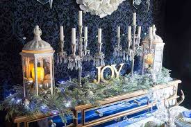 Modern christmas table with a dark tablecloth, evergreens and white star candle holders. Pantone Classic Blue For Christmas Decor Khk Designs