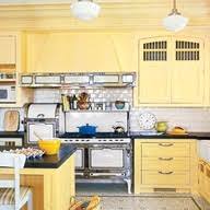 Cabinet diy has the largest collection of painted cabinets. Golden Yellow Cabinets Warm Up The Shiny White Surfaces And Cool Black Countertops Of This Vintage Victori Yellow Kitchen Kitchen Design Kitchen Cabinet Colors