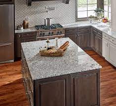 The glazed grey subway backsplash tiles are installed in the herringbone pattern. Perfect Pairings For Granite Countertops And Tile Backsplashes