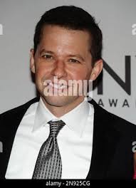 This Sunday, June 5, 2011 photo shows photographer Jason Chee, right, as he  checks his images