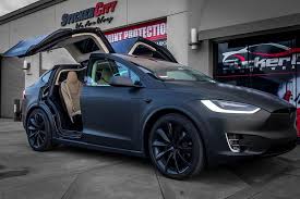 Tesla model x black satin gold dust vinyl wrap with carbon fiber accents on chrome and all 6 seat backs. Stickercity 2017 Tesla Model X Wrapped In Matte Black Facebook