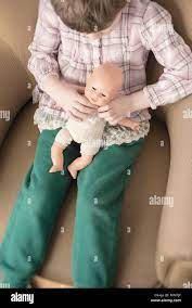 Girl holding toy dolls hi-res stock photography and images - Alamy