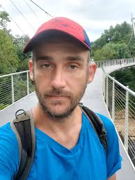 Me at the Reedy River pedestrian cable stay pedestrian bridge in Falls Park.