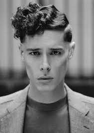 In the 1920s, men with curly hair would apply a little product and occasionally create a finger wave or two. Criminal Paths Collection A Twist On Barbered Looks From The 20s 1920s Mens Hair Haircuts For Men Mens Hairstyles