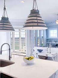Coastal Inspired Silver Gray Tiered Pendants Bring The Feel Of The Ocean To This Open Concept Design Living Room And Kitchen Design Open Concept Concept Design