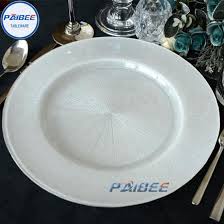 A charger plate is a large, decorative plate that is used as a placeholder before the meal. China Champagne Wedding Rental Glass Charger Plate Table Decoration For Birthday Party China Charger Plates And Wedding Charger Plates Price