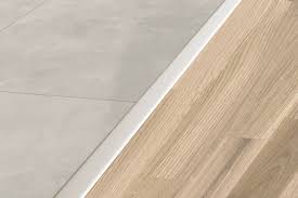 Since your floor trim acts as a buffer between the laminate flooring and the baseboards, it needs a good glue application. Schluter Reno T Same Height Transitions For Floors Profiles Schluter Com