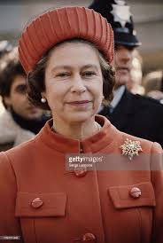 Queen Elizabeth II wearing an orange coat and hat, London, UK, circa...