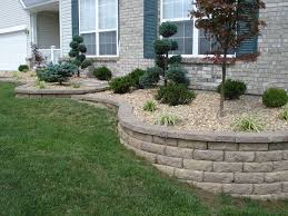 The retaining wall is an ideal spot for decorative planters. Slope Front Yard Retaining Wall Ideas Novocom Top