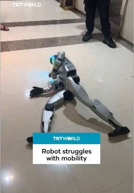 A robot struggles to walk, repeatedly falling forward and moving awkwardly in random directions, until people step in to stop it in China’s Henan. #humanoidrobot #chineserobot