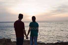 Maybe you would like to learn more about one of these? Silhouette Of Couple Holding Hands On Beach At Sunset Young Man Affection Stock Photo 208503168