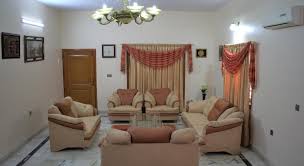 Glass lamps with blue glass embellishments top the mother of pearl bedside tables. Guest Room Design In Pakistan