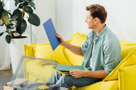 You love its three vertical cubbies and knew it would be the perfect home for your record collection. Side View Of Man Holding Vinyl Records Near Record Player And Books On Coffee Table In Living Room Free Stock Photo And Image
