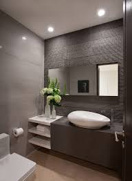 In this gray and brown bathroom, the rustic wood flooring is combined with the plain gray wall which creates a very mesmerizing look. Stone Finish Powder Room Contemporary With Vases Lever Handles Modern Toilet Toilet Design Bathroom Layout