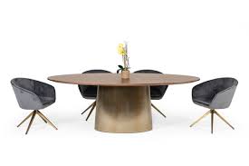 Gather up to eight people around the oval tabletop, constructed of wood veneer and showcasing a beautiful yet subtle starburst pattern. Modrest Emil Modern Walnut Brass Oval Dining Table