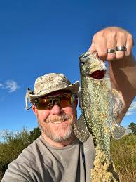 Weighing Stripe Bass in a Pond