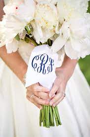 The bride and dress grabbing tradition died down as a result of this new sneaky trick, as guests realised they could just remain calm and wait for the bouquet, and soon tossing the bouquet became a key part of every fancy wedding. 14 Wedding Monogram Ideas Weddings Illustrated Ribbon Bouquet Bouquet Wrap Bridesmaid Bouquet