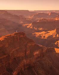The key is to be looking away from the actual sunrise/sunset since the interplay of the lighting/shadows on the canyon walls is amazing. Sunset Over Grand Canyon By Roland Shainidze Photogaphy