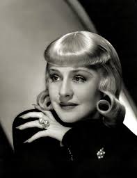 Night shot of Grauman's Chinese Theater with a banner for “Idiot's Delight”  stretched across Hollywood Blvd, February 1939 |