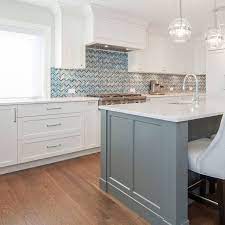 Large white and blue kitchen boasts a blue island donning a white and gray marble countertop lit by three carriage lanterns. 75 Blue Backsplash Ideas Navy Aqua Royal Or Coastal Blue Design Blue Backsplash Blue Backsplash Kitchen Mosaic Backsplash Kitchen