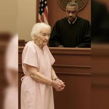 She's 91 years old, standing in a hospital gown, hands in chains. Arrested for felony theft. The judge could hardly believe it. Helen and her husband George, 88, have been married 65