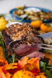 Muffin tin potatoes gratin on a white dish with parsley garnish. This Old English Prime Rib Recipe Is Perfect For The Holidays Malibu Magazine