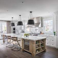 If you already have bold kitchen cabinetry, look to a contrasting wood finish to make your island stand out. Honey Stained Oak Island With Turned Legs Cottage Kitchen