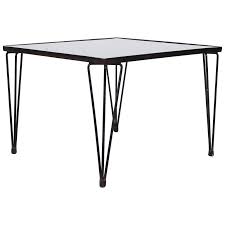 Black medium rectangle glass coffee table with chrome plated legs. A Bueno De Mesquita Style Black Glass Coffee Table With Hairpin Legs For Sale At 1stdibs