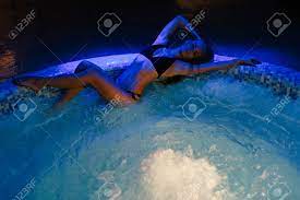 Beautiful Young Sexy Woman Lying Down On Edge Of Hot Tub Stock Photo,  Picture and Royalty Free Image. Image 69867595.