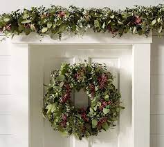 The tropical, evergreen eucalyptus provides a unique natural texture, while red berries hint at holly stems. Fresh Holiday Eucalyptus Berry Wreath Pottery Barn