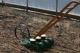 This Incredible Wheel Hoe And Seeder Setup Allows You To Plant Multiple Rows At A Time Using Four Spreader Bar Extensions An Garden Seeds Planters Seed Planter