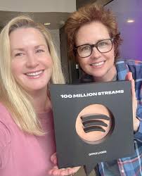 The ladies celebrating 100 million streams!