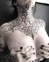 Bold Ornament On Caro Voodoo Thank You For Your Trust And Endurance Tattoo Ink National Neck Tattoos Women Chest Piece Tattoos Chest Tattoos For Women
