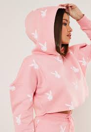 A character wearing a playboy bunny outfit, also known as a bunnysuit or a bunny girl. Playboy X Missguided Pink Bunny Repeat Print Cropped Hoodie Missguided