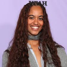 Sasha Obama relaxes under a tree while reading a novel