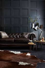 05 A Moody Living Room With A Dark Brown Leather Sofa And A Matching Animal Skin Rug Digsdigs Dark Living Rooms Interior House Interior