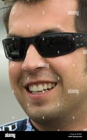 NASCAR driver Sam Hornish Jr., right, smiles as he talks to his wife  Crystal and their daughter Addison before the NASCAR Sprint Cup Series  Pennsylvania 500 auto race in Long Pond, Pa.,