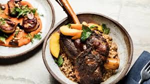 Choose from our luxurious & affordable lamb dishes and impress your friends! Top Chef Fan Favorite Chris Crary Serves Up A Dinner Party Ready Recipe For Wine Braised Lamb Shanks Over Farro F Braised Lamb Shanks Braised Lamb Lamb Recipes